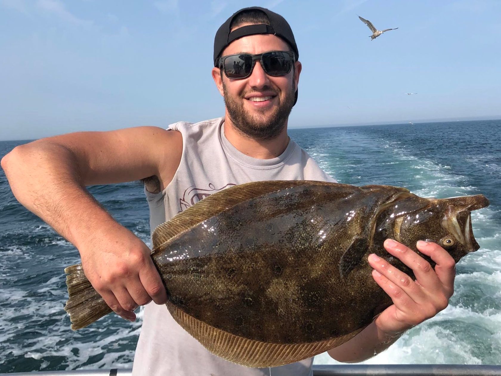 a man holding a fish in the water