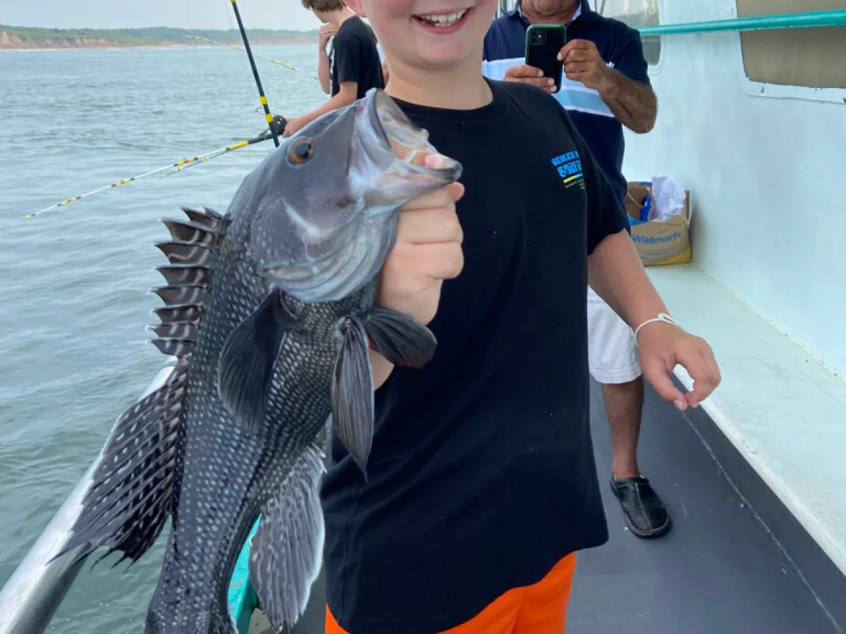 a person holding a kite while standing in the water