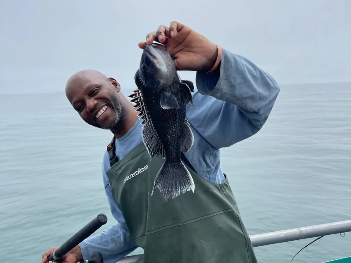 a person in a green boat on a body of water