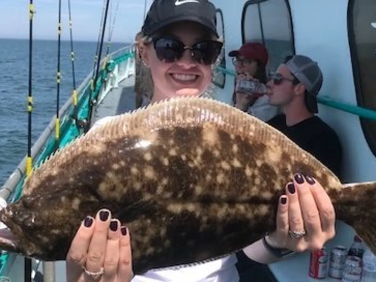 a man holding a fish on a boat