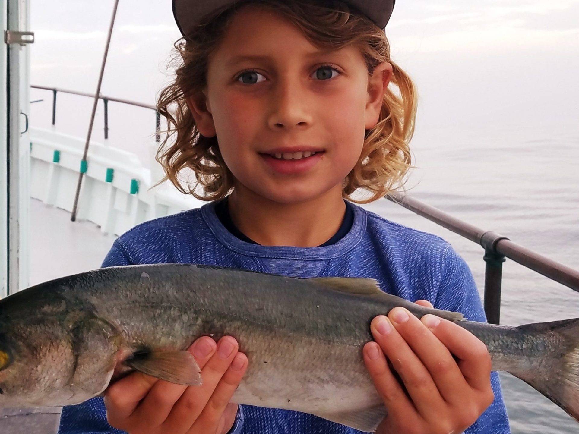 a young boy holding a fish