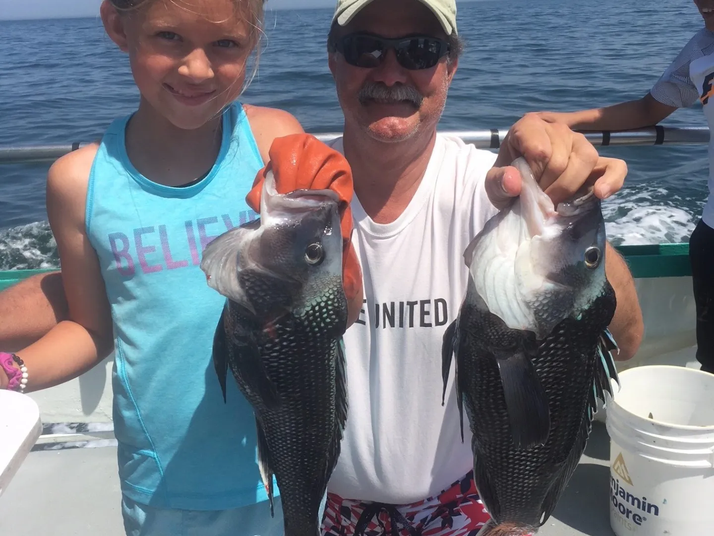 a person holding a fish in the water