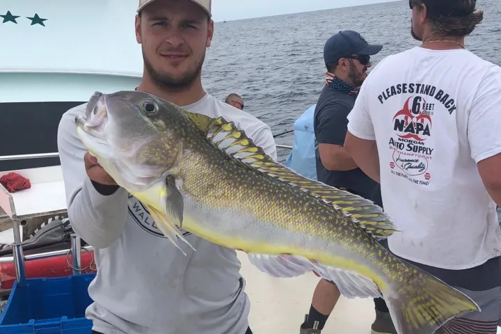 a man holding a fish