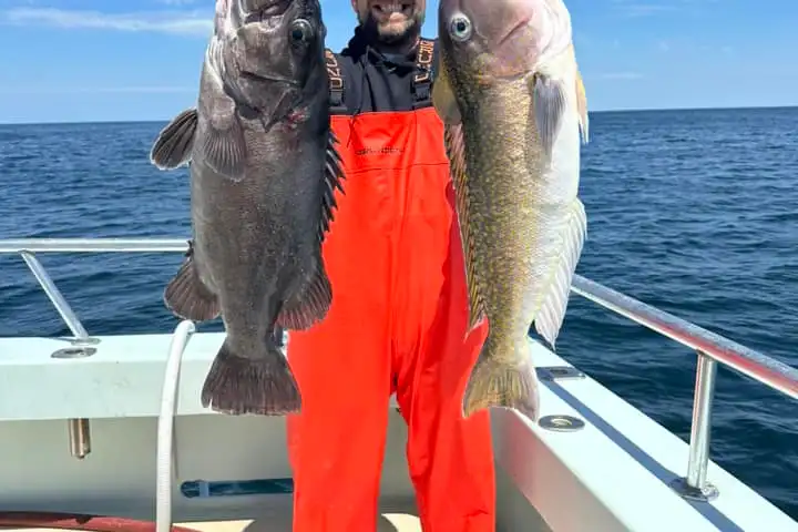 a man holding a fish in the water