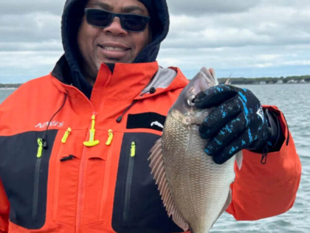 a person holding a fish in the water