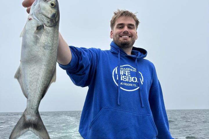 a man holding a fish in the water