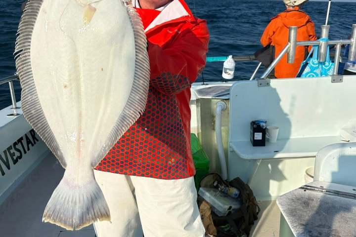 a man standing next to a boat