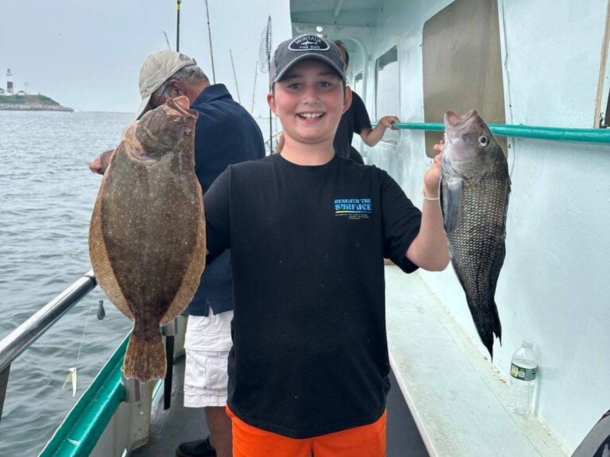 a man holding a fish on a boat
