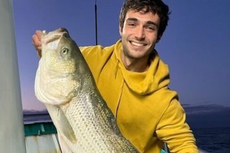 a man holding a fish