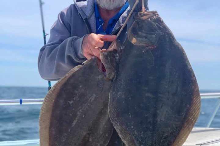 a man holding a fish in the water