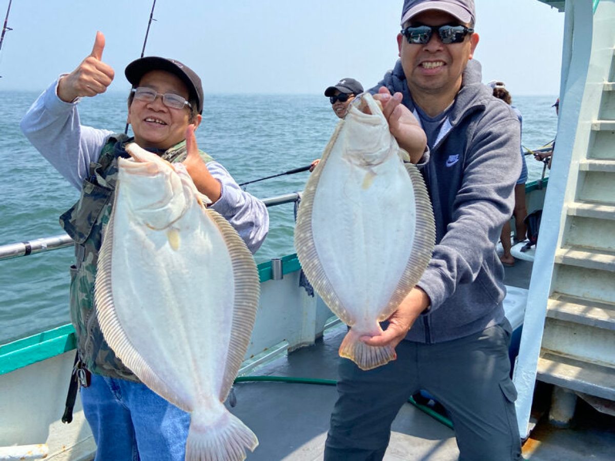 a man and a woman holding a fish