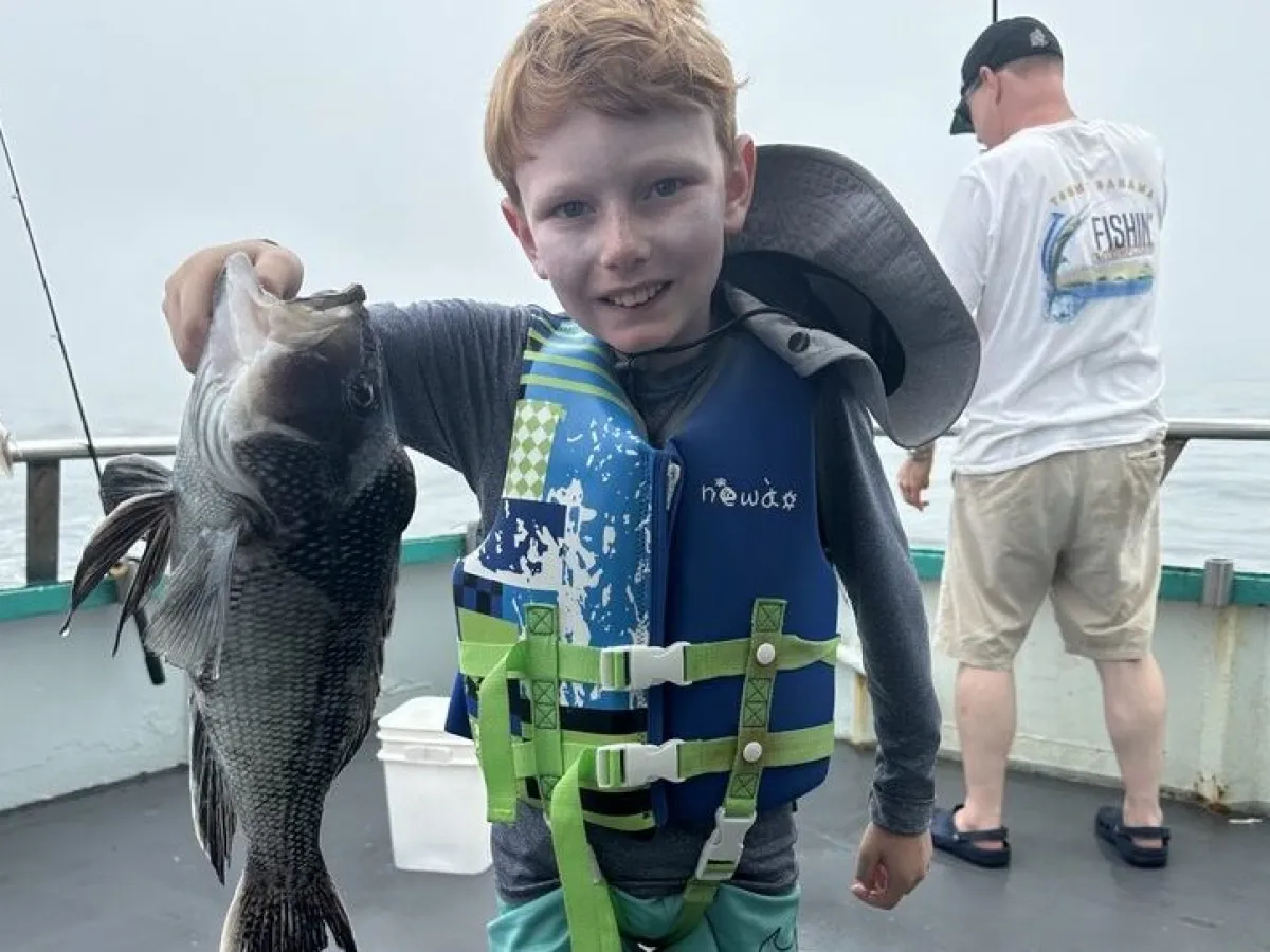 a man holding a fish