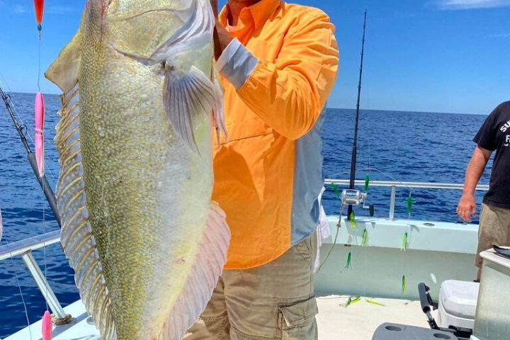 a man holding a fish