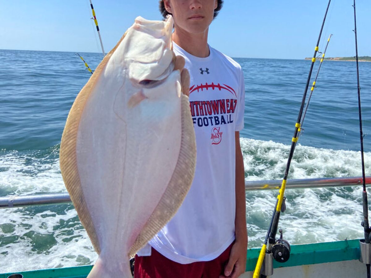a man holding a fish in the water