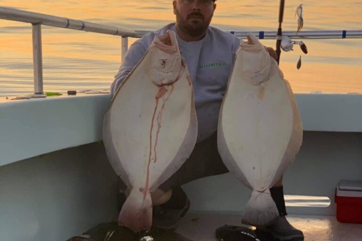 a person holding a fish in the water