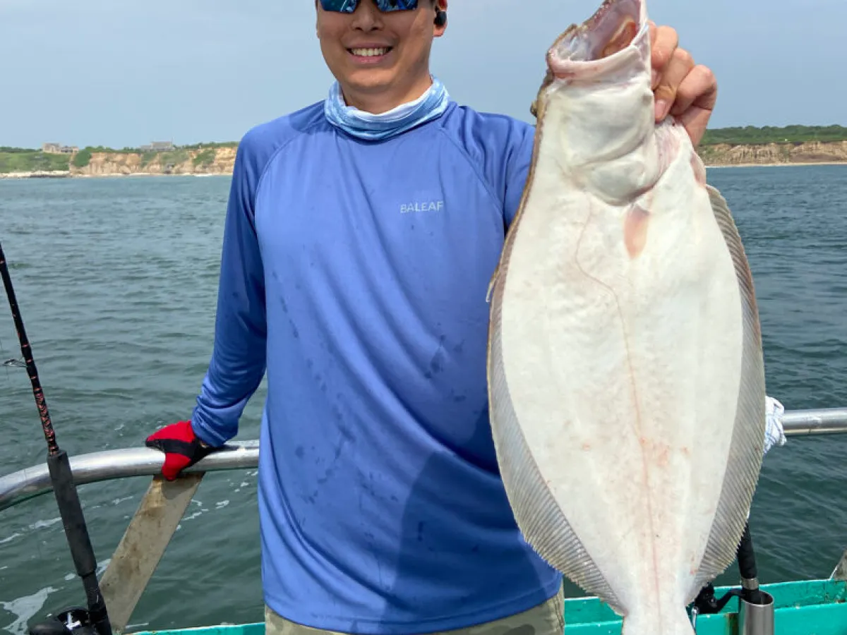 a man holding a fish in the water