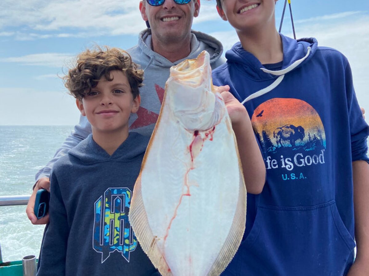 a young boy holding a fish