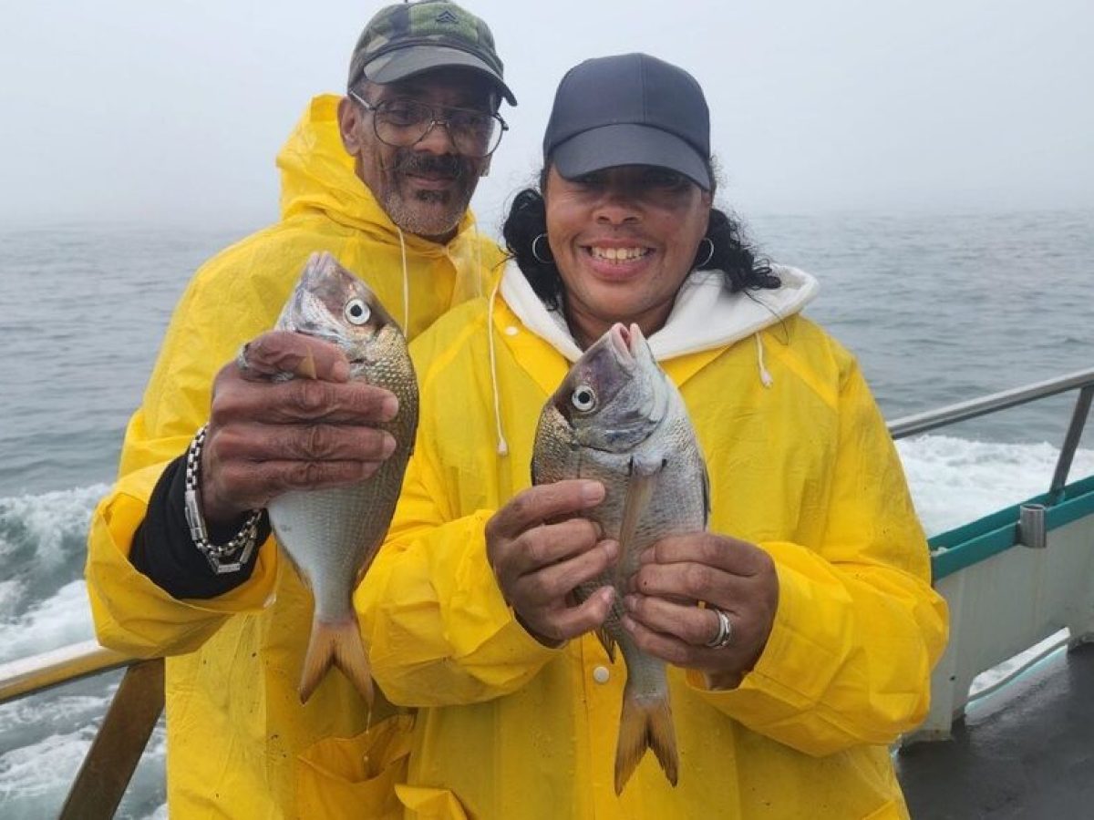 a person holding a fish in the water
