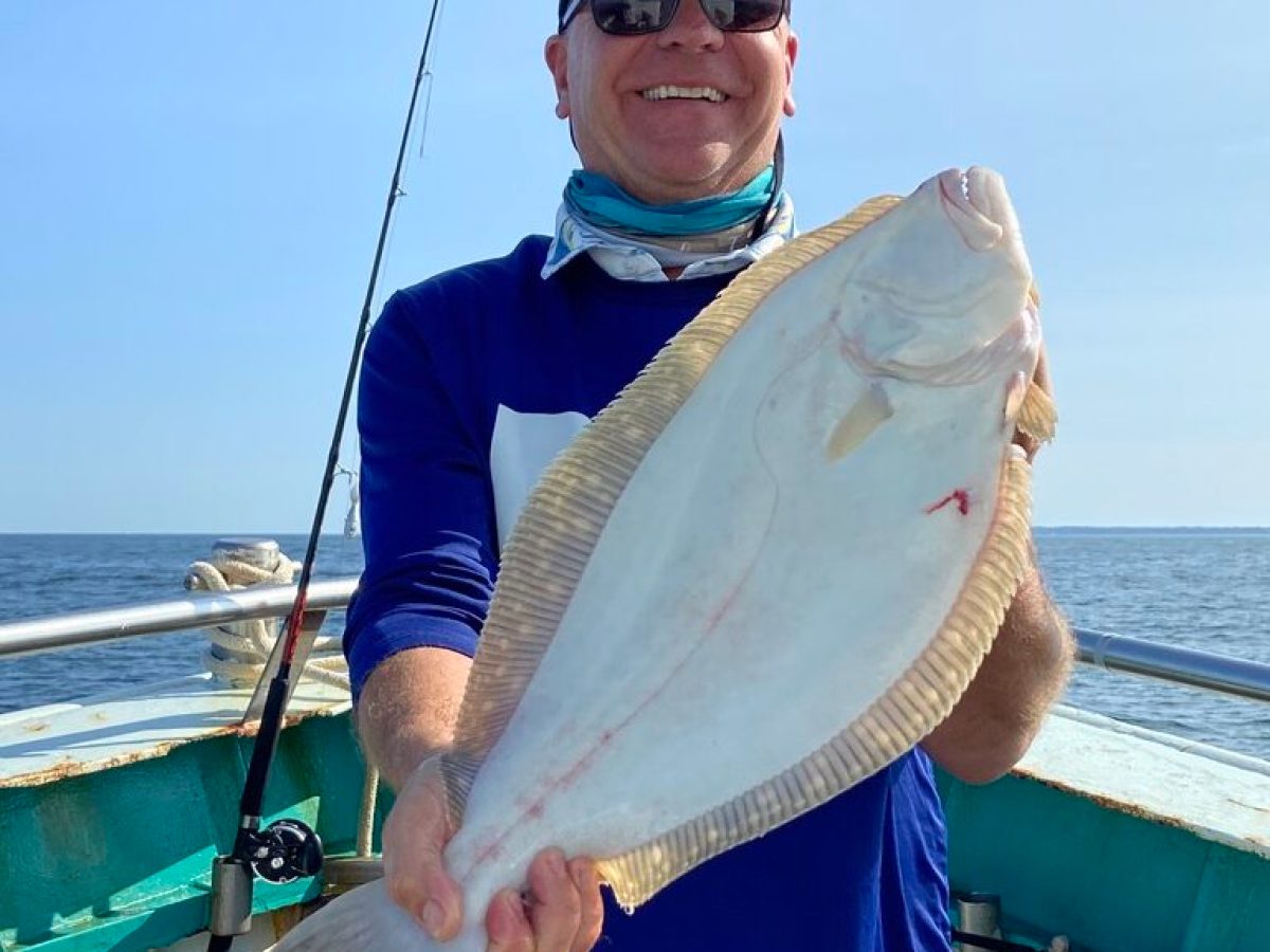 a man holding a fish in the water