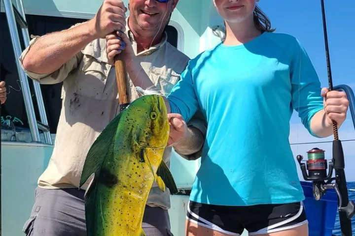 a woman holding a fish