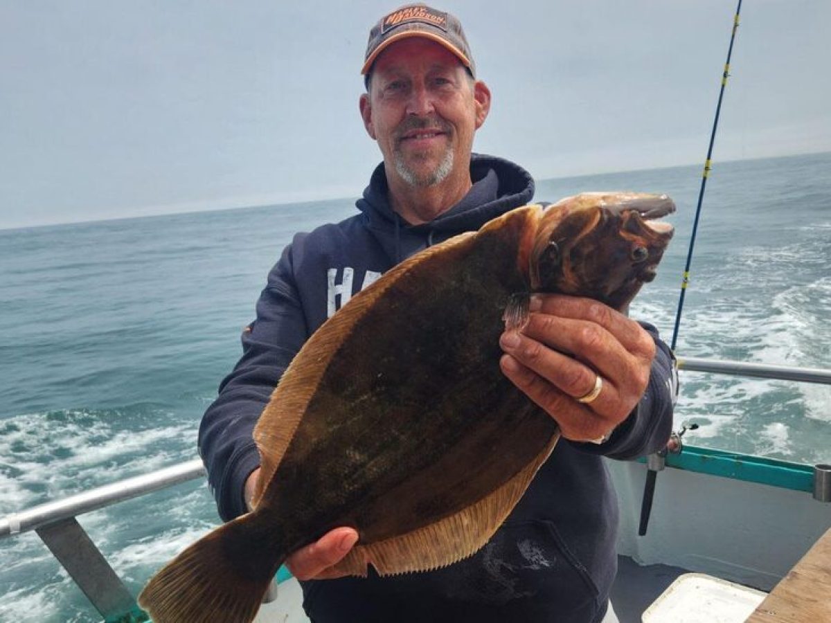 a man holding a fish in the water