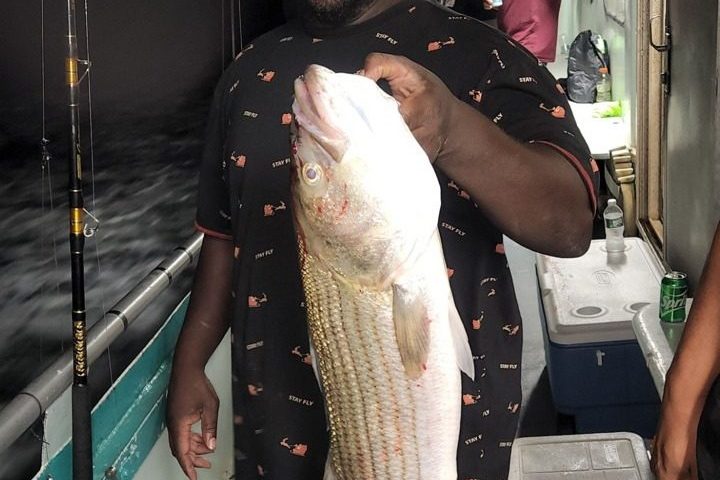 a person holding a fish