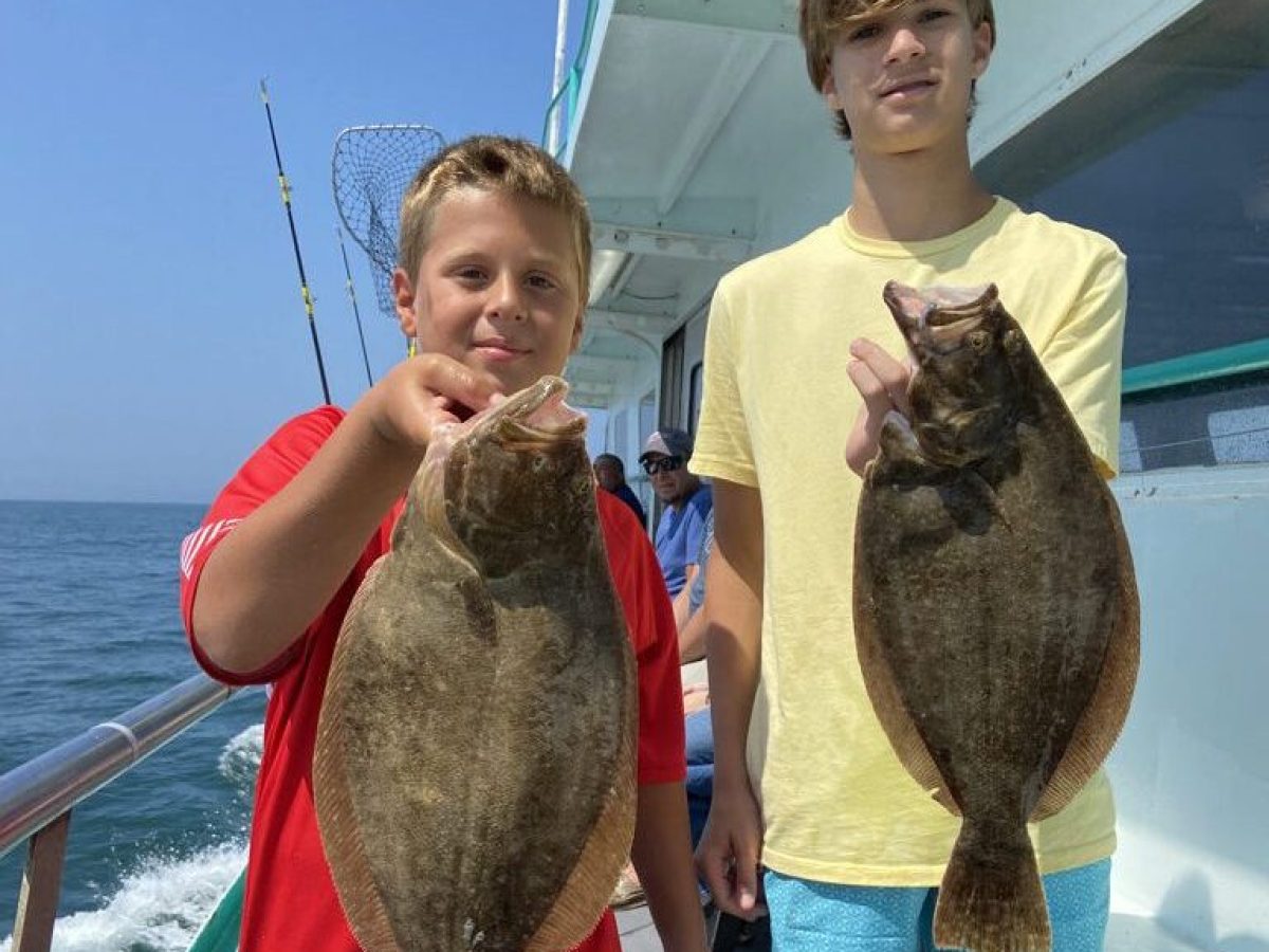 a man holding a fish in the water