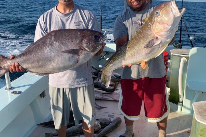 Christopher Alao-Akala holding a fish in the water