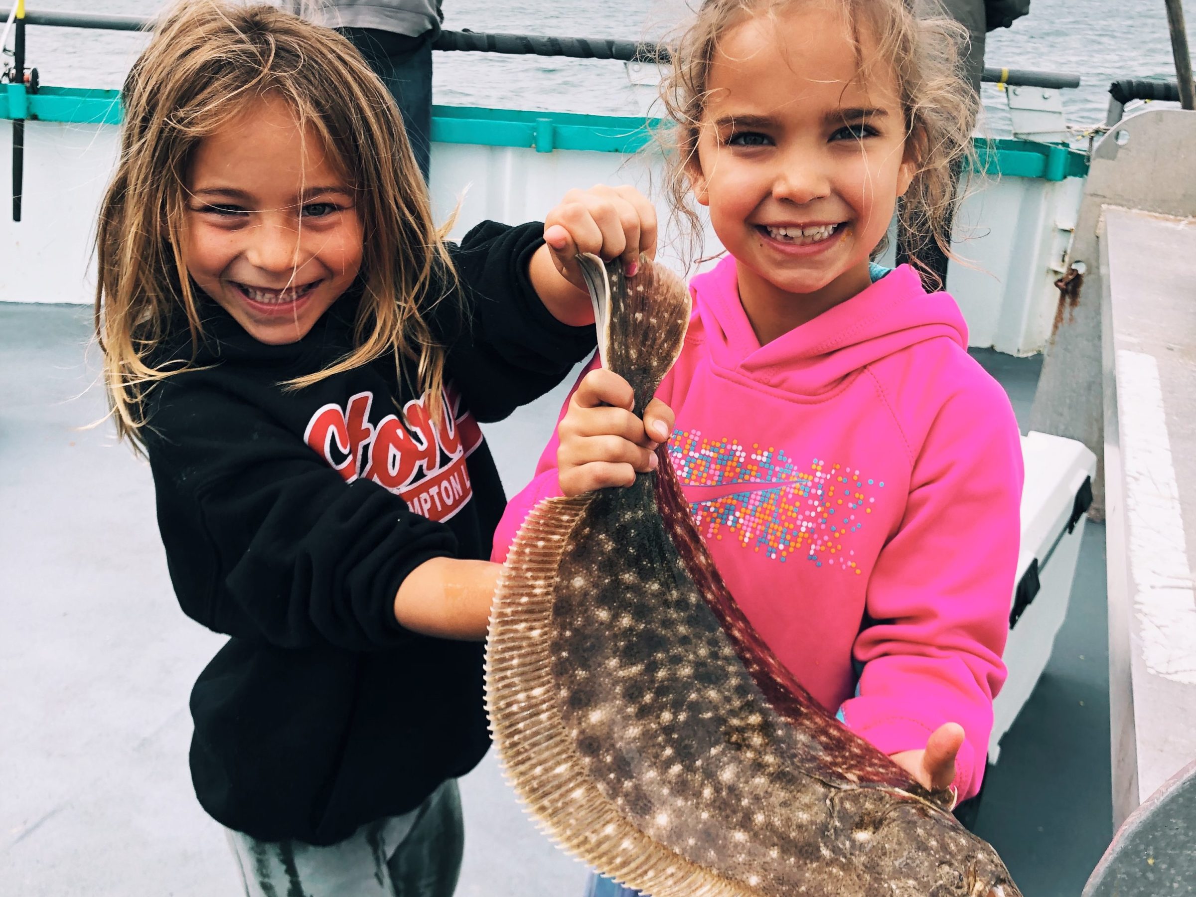 a little girl standing next to a child