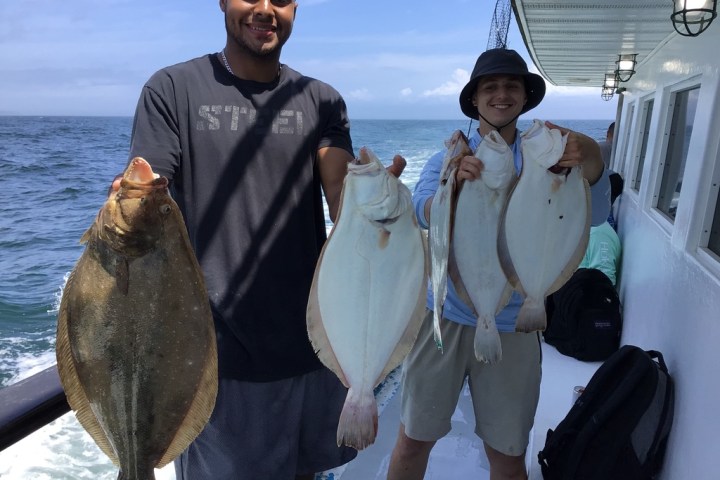 a man holding a fish in the water