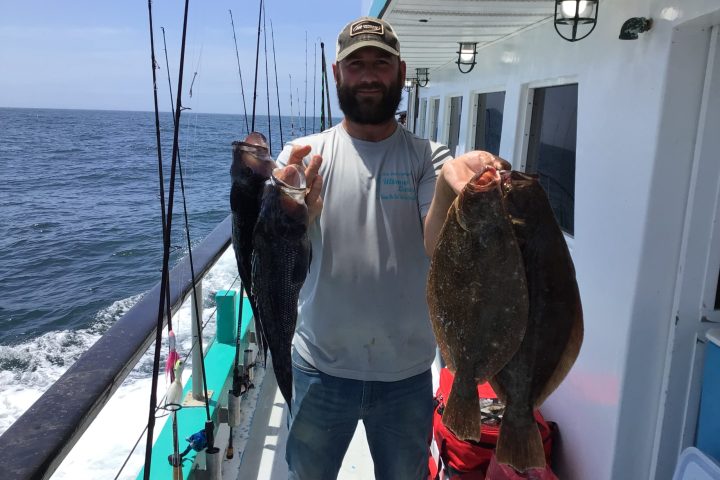 a person holding a fish in the water