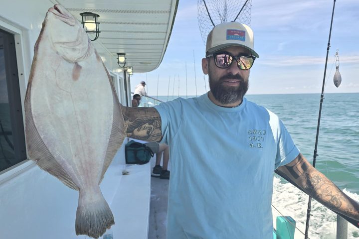a man holding a fish in the water
