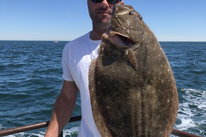 a man holding a fish in the water