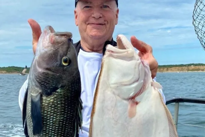 a person holding a fish in the water