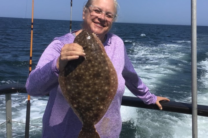 a person standing next to a body of water