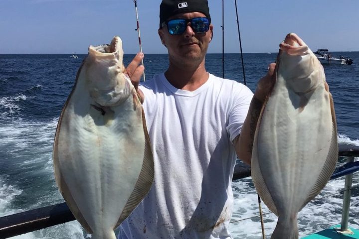 a man holding a fish in the water