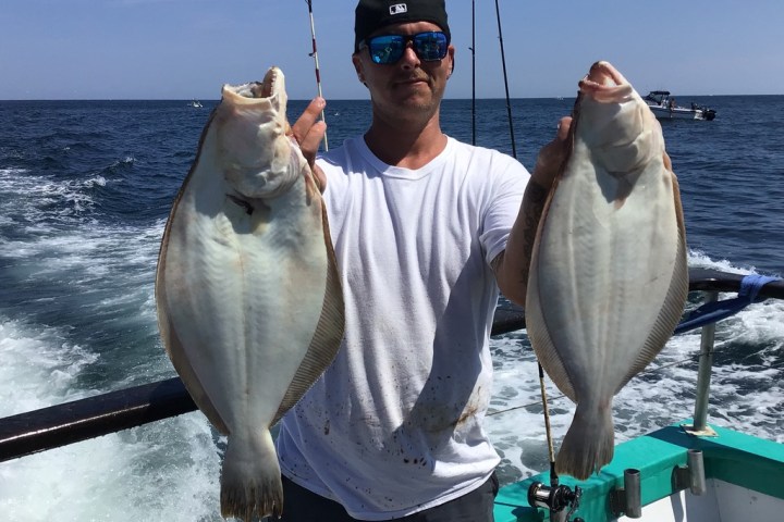 a man holding a fish in the water