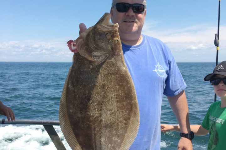 a man holding a fish in the water