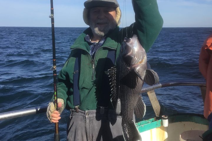 a person standing next to a body of water