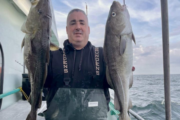 a person holding a fish