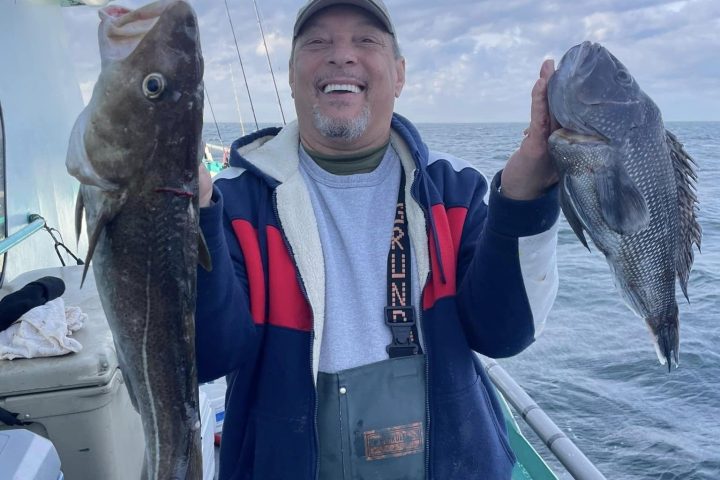 a person holding a fish on a boat