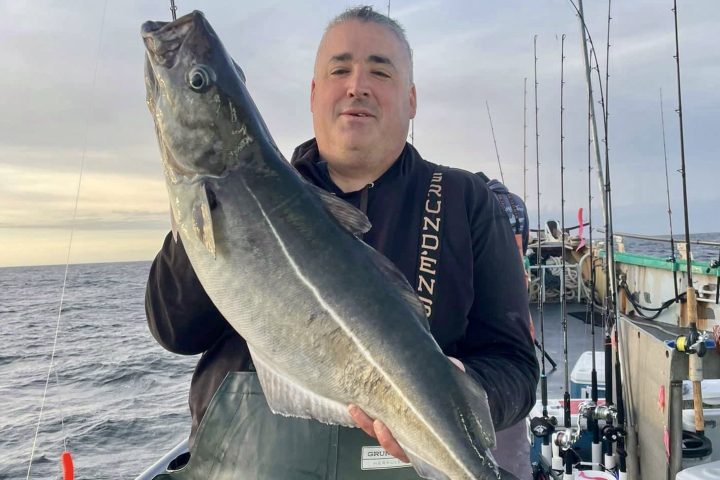 a man holding a fish in the water