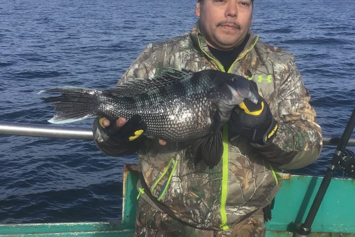 a man standing next to a body of water