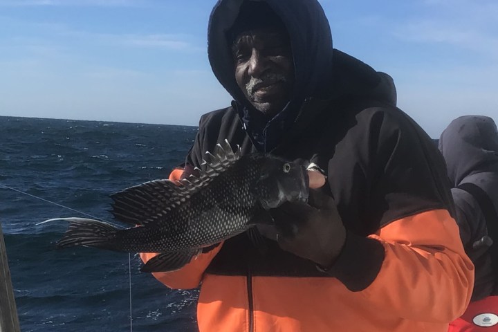 a man sitting on a boat in the water