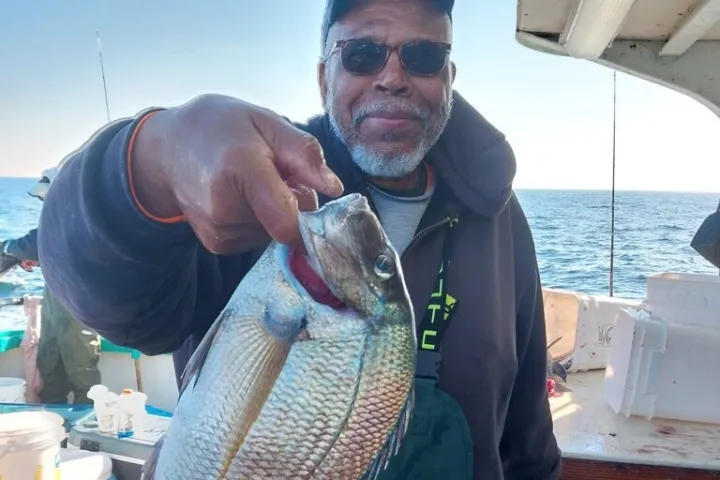 a man holding a fish