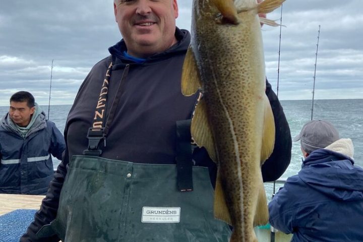 a person holding a fish