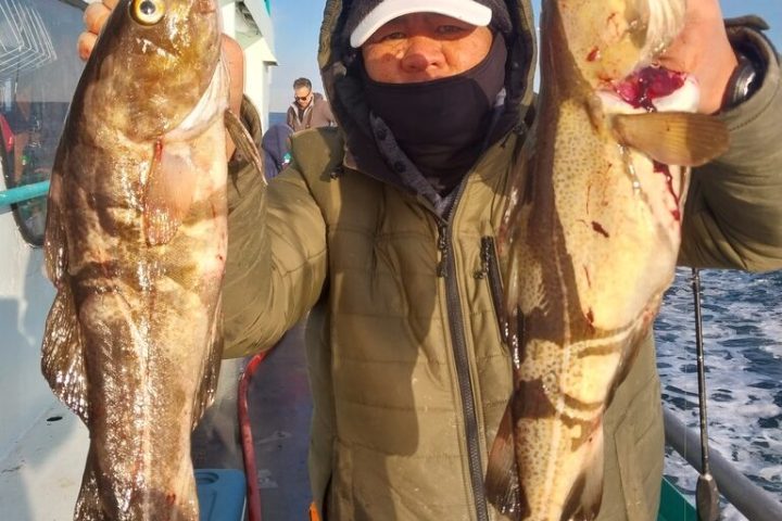 a couple of people that are standing in the middle of a fish