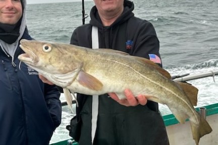 Patrick Jones holding a fish in the water