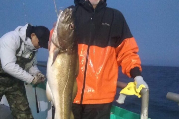 a man holding a fish