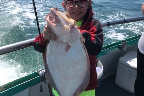 a person holding a fish in the water